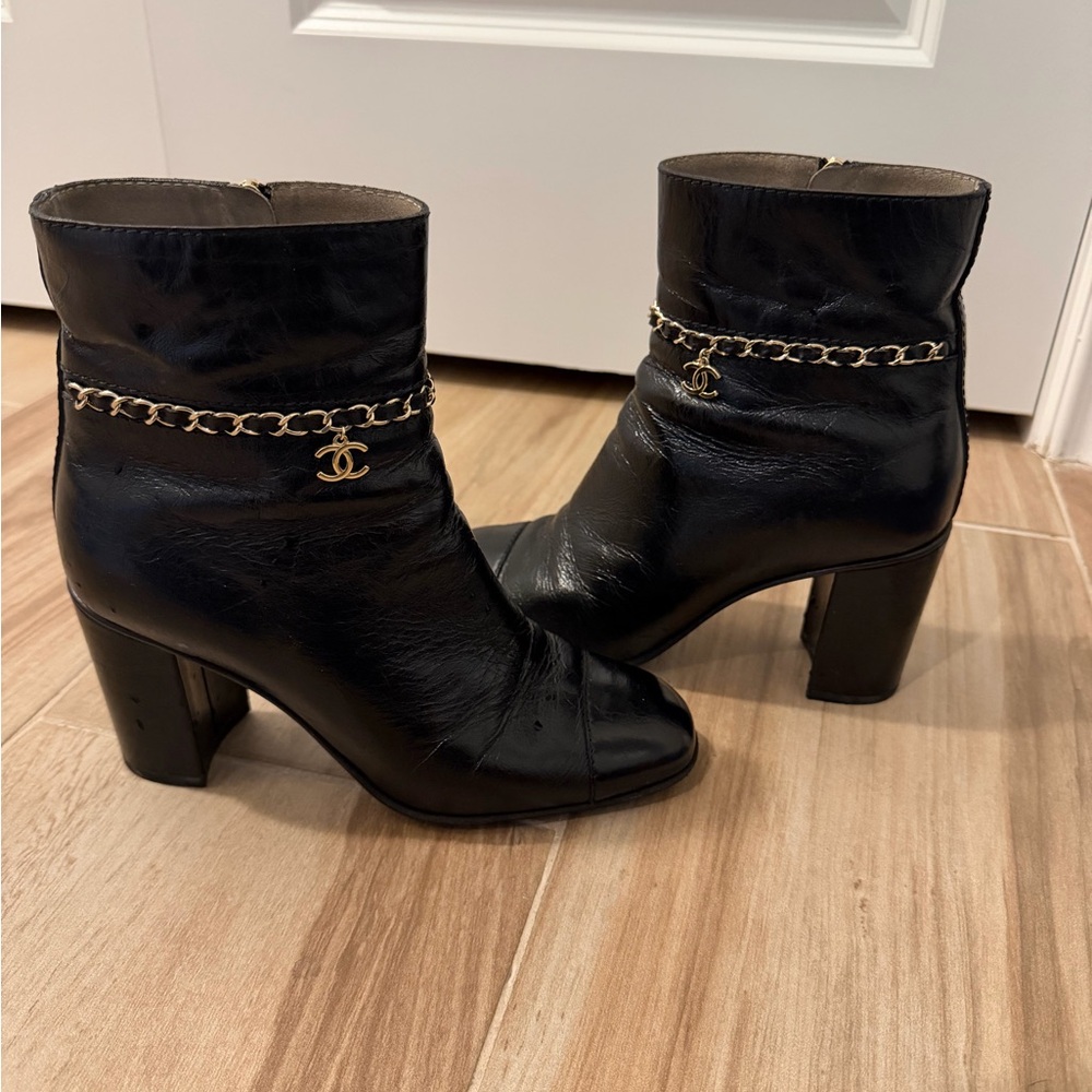 CHANEL Black Heeled Boots with Gold Chain Accent